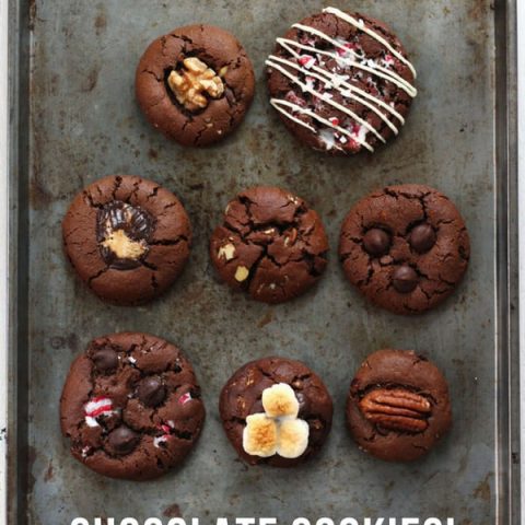 Chocolate cookies in eight flavors on a baking sheet.