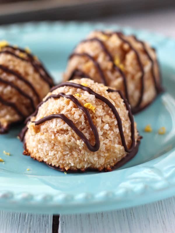 A small blue plate with three chocolate coconut macaroons.