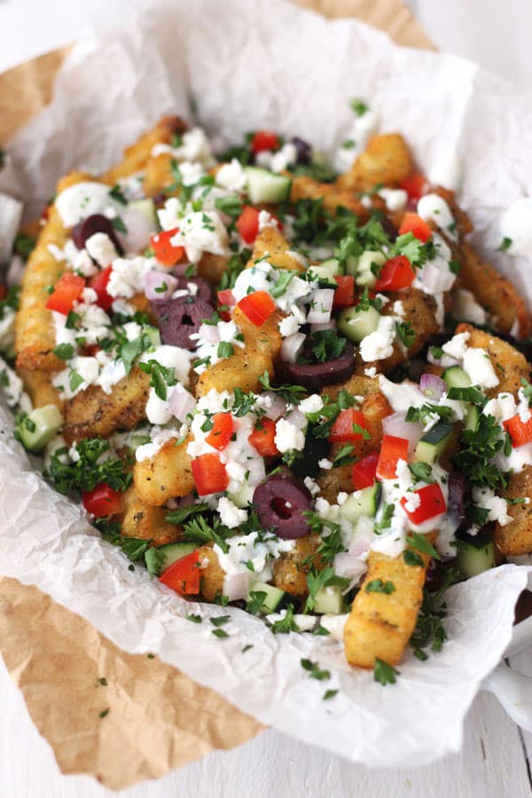 Baked fries loaded with feta, tomatoes, olives, and parsley.