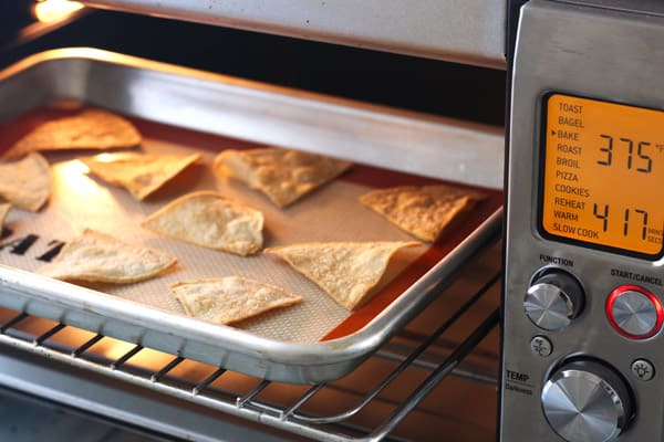 Day old chips on baking sheet in a toaster oven.