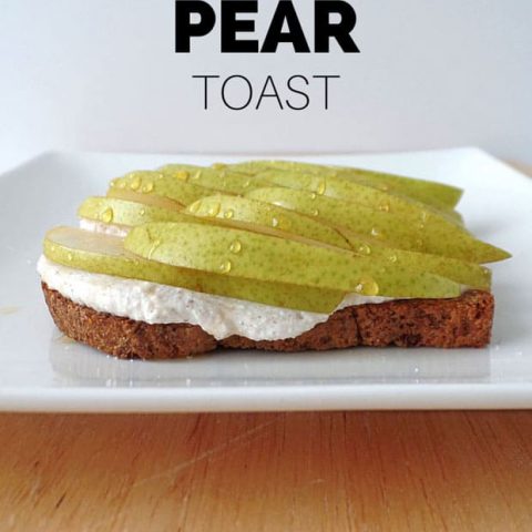 Piece of toast topped with ricotta and pear slices.