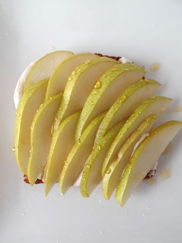 Overhead view of plate with toast topped with slices of fresh pear.
