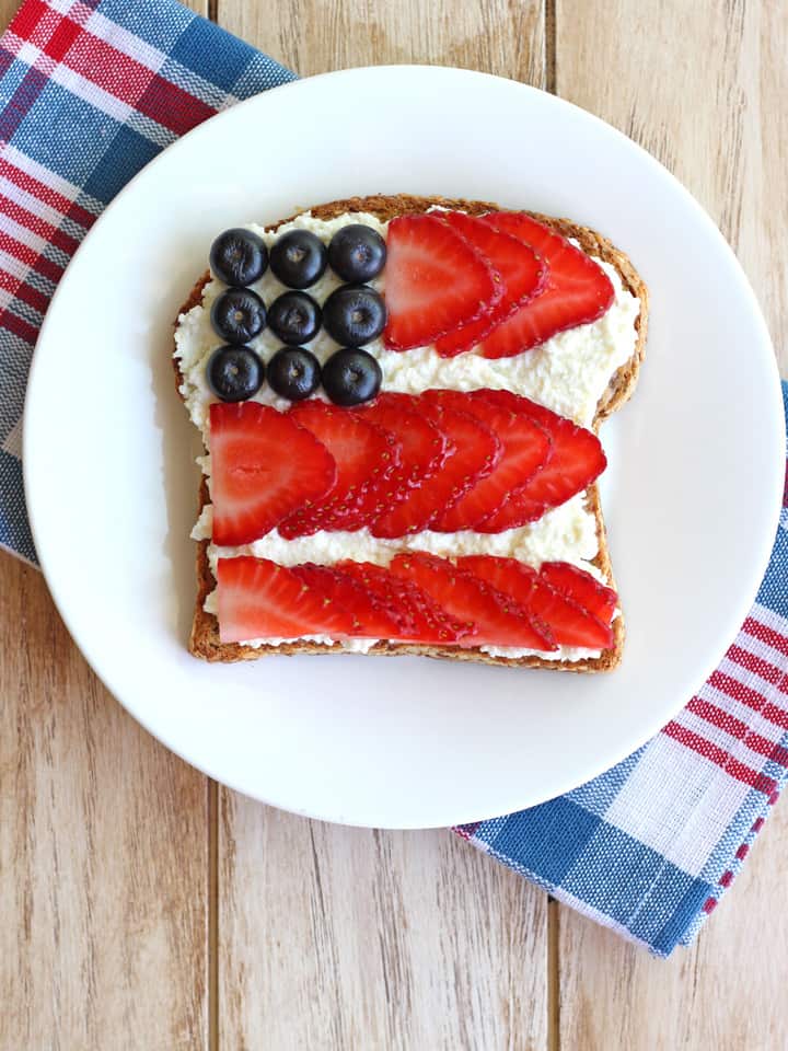 Toast topped with ricotta and berries in the shape of a flag.