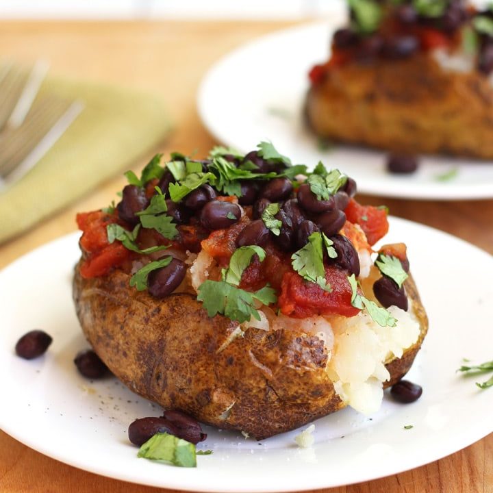 Baked potato topped with black beans and salsa.
