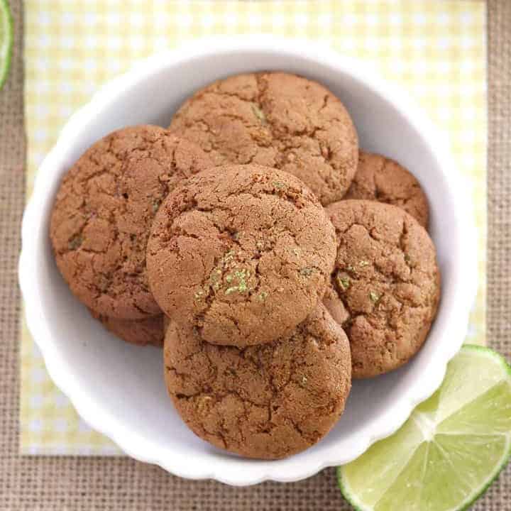 Cookies in a small white bowl on a yellow napkin.