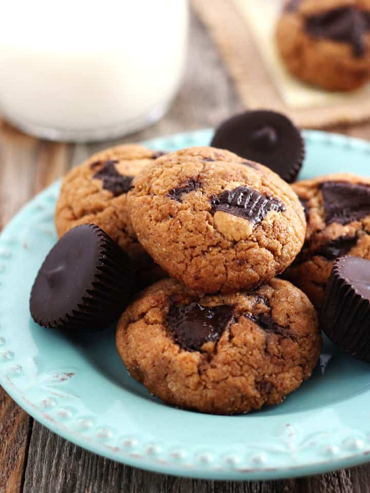 Peanut butter cookies and mini peanut butter cups on a small blue plate.