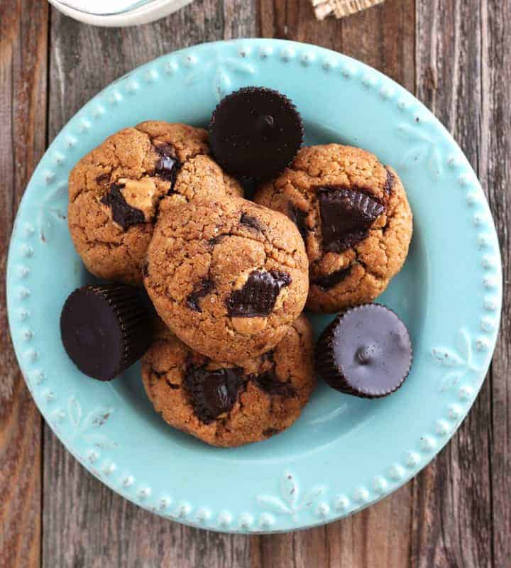 Overhead view of a plate of peanut butter cookies and mini peanut butter cups.