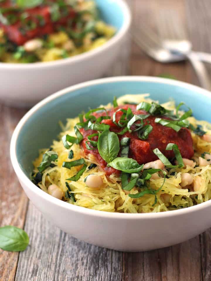 Bowls of spaghetti squash on a wooden table.