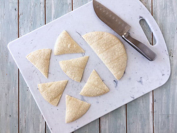 Corn tortillas sliced into wedges.