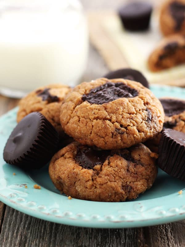 A blue plate with peanut butter cookies on a wooden table.