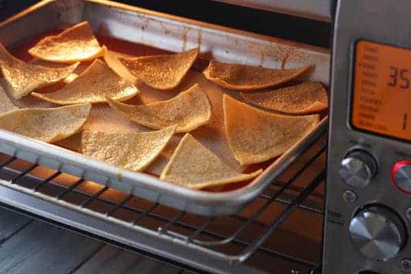 Tortilla slices baking in a toaster oven.