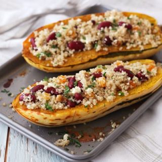 Filled delicata squash boats on a toaster oven baking pan.