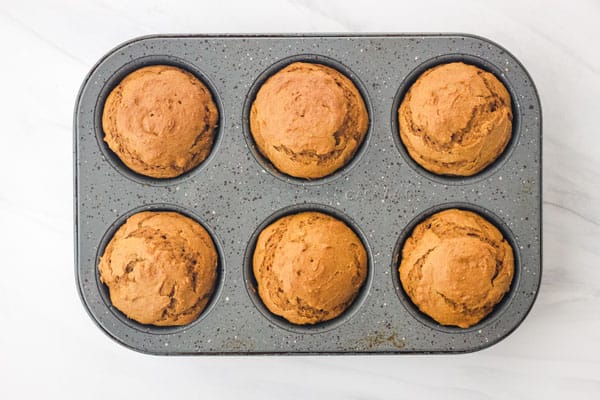 Overhead view of muffins baked in a tin.