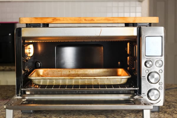 Empty quarter sheet pan inside of a countertop oven.