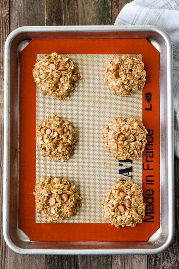Cookie mounds on a silpat lined sheet pan.