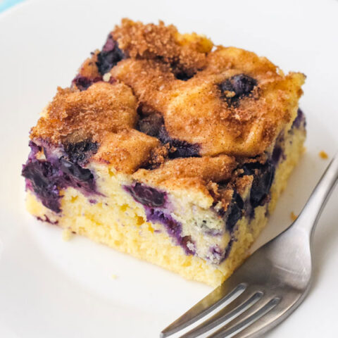 Piece of coffee cake on a white plate with a fork.