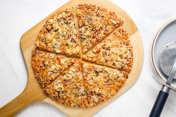 Overhead view of sliced pizza on a pizza peel.