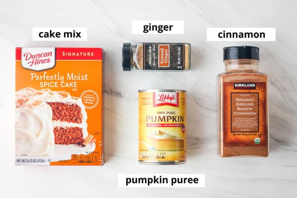 Box of cake mix, can of pumpkin, jars of cinnamon and ginger