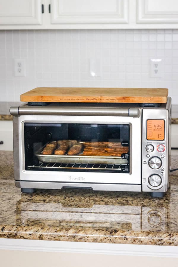 Sheet pan of food inside a convection toaster oven.
