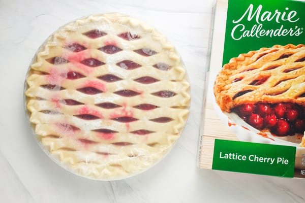 Frozen cherry pie next to box.