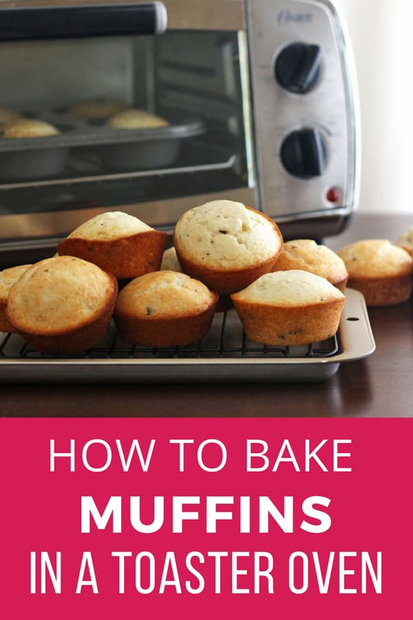 Muffins cooling on a pan in front of a toaster oven.
