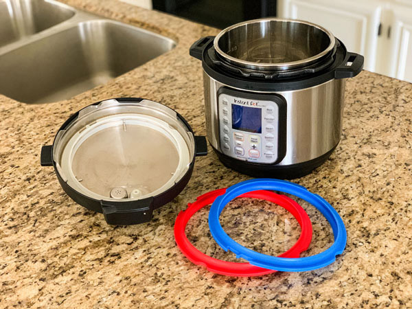 Instant Pot Mini on counter with blue and red silicone rings.