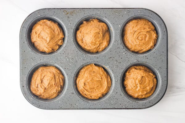 Muffin batter in 6-cup muffin pan.
