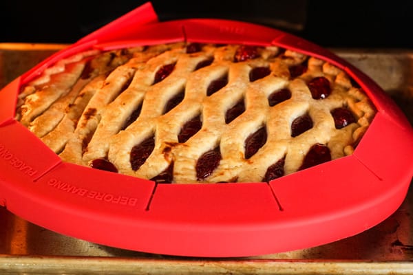Close up of golden browned and bubbly pie inside of toaster oven.