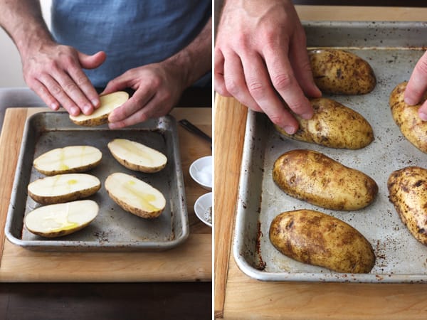 Potato halves rubbed with oil on a baking sheet.