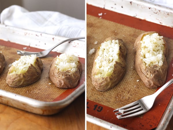 Oil-free baked potato halves on a silicone baking mat lined sheet pan.