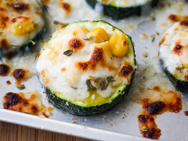 Zucchini slice topped with salsa, corn, and cheese.