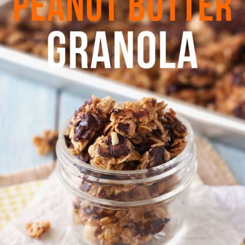 Clusters of chocolate covered peanut butter granola in a small glass jar.