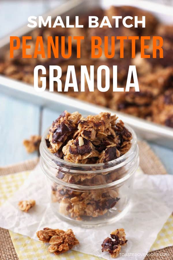 Clusters of chocolate covered peanut butter granola in a small glass jar.