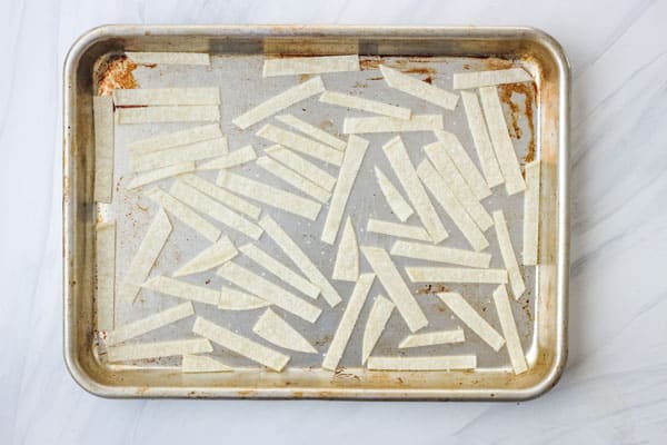 Tortilla pieces on a baking sheet.