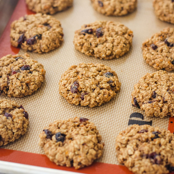 Loaded with great cranberry-orange flavor, this simple recipe for toaster oven cookies make a great late night dessert or lunchbox treat! Oatmeal cookies on a silicone baking mat.