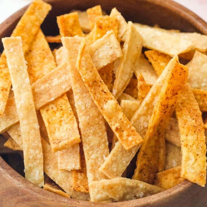 Closeup of seasoned strips in a wooden bowl.