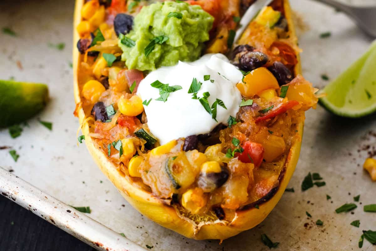 Overstuffed spaghetti squash topped with dollops of guacamole and Greek yogurt.