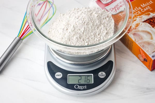 Bowl with cake mix on a kitchen scale.