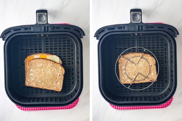 Sandwich in air fryer with bread sliding and with a round metal trivet on top of the sandwich.