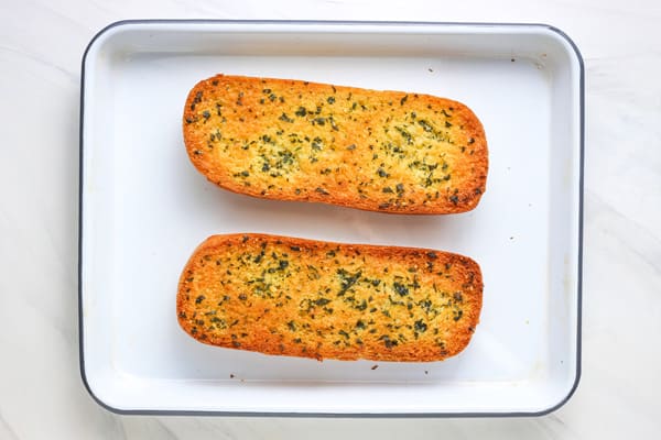 Overhead view of toasted golden brown garlic bread rolls.