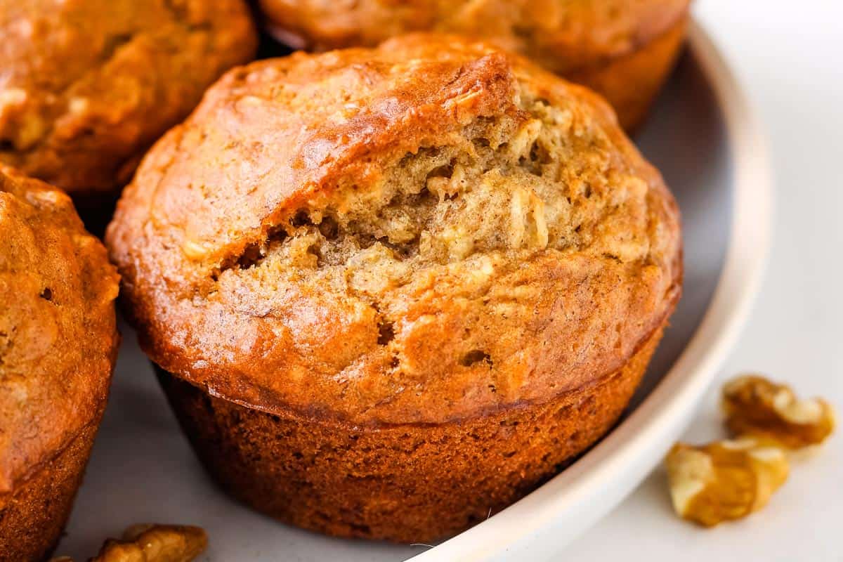 Closeup of baked banana oatmeal muffins on a plate.