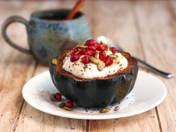 acorn squash bowl filled with yogurt, pomegranate and chia seeds