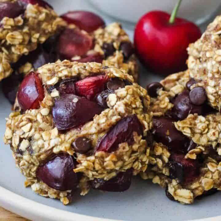 Closeup of cherry pieces and mini chocolate chips in banana oat cookies.
