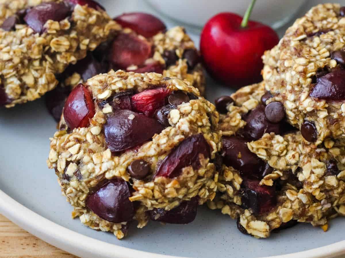 Closeup of cherry pieces and mini chocolate chips in banana oat cookies.