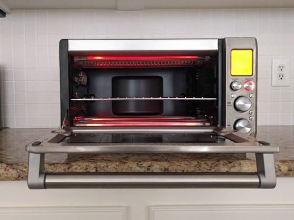 Toaster oven with door open showing red hot coils.