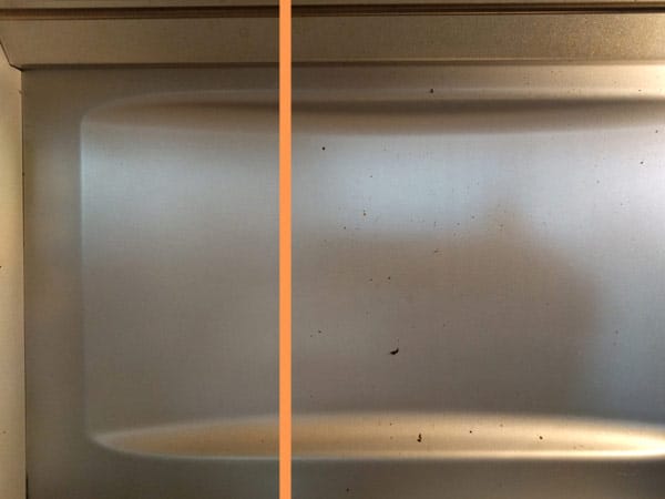 Rear wall of a dirty toaster oven.