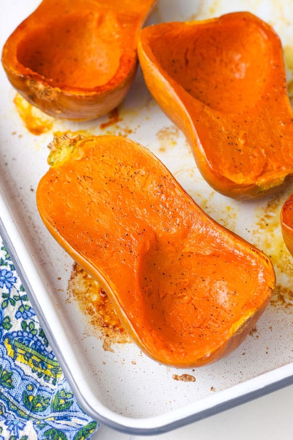 Closeup of roasted squash half on pan.