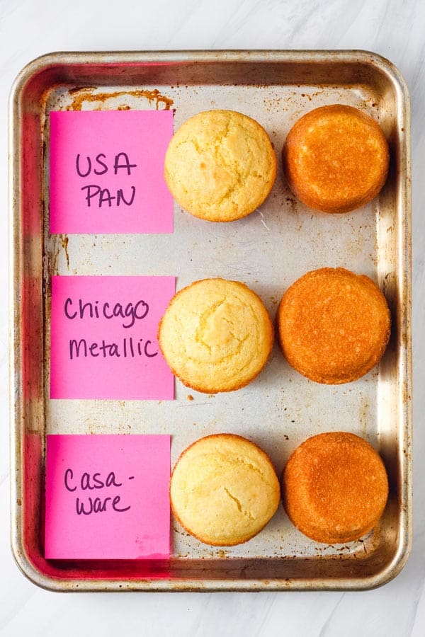 Three sets of corn muffins showcased and labeled on a pan.