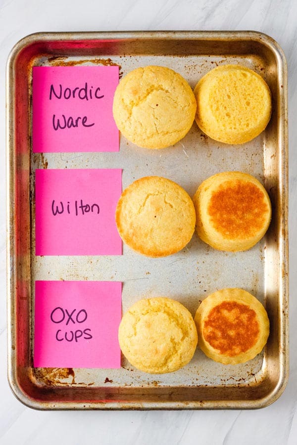 Corn muffins with very little browning labeled on a sheet pan.