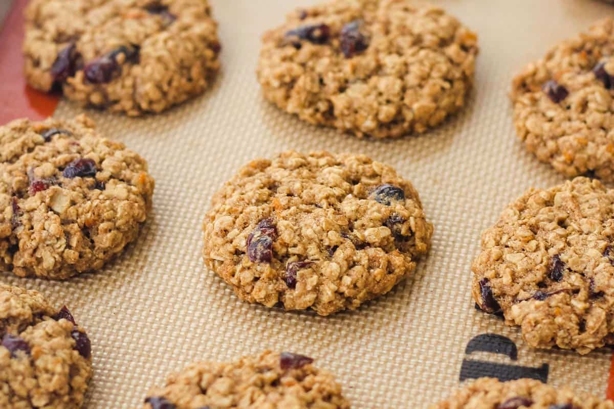 Closeup of baked cookies on a lined sheet pan.